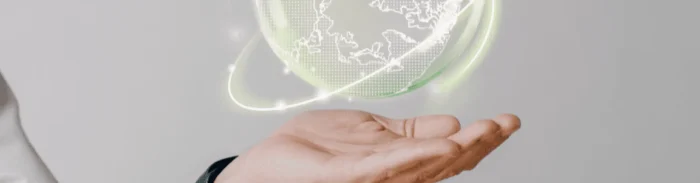 Hand holding a glowing digital hologram of Earth