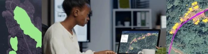 Woman in office using Picterra platform on laptop to analyze satellite imagery of roads and houses