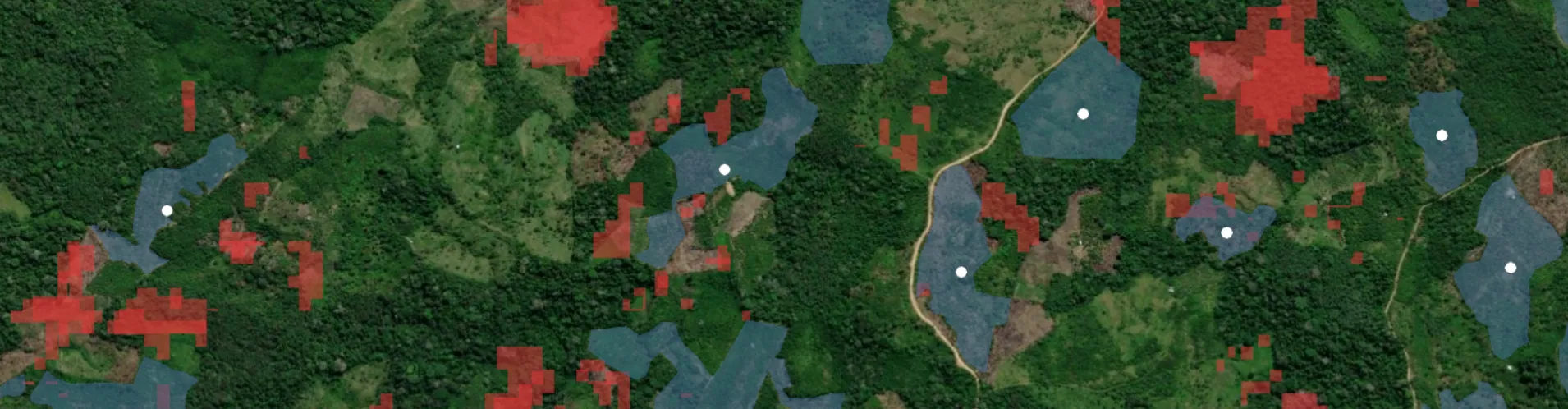 Satellite image of forest and farmland with red and blue overlays showing deforestation risk zones