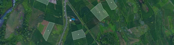 Aerial view of terraced farmland with highlighted plots marked for geospatial analysis.